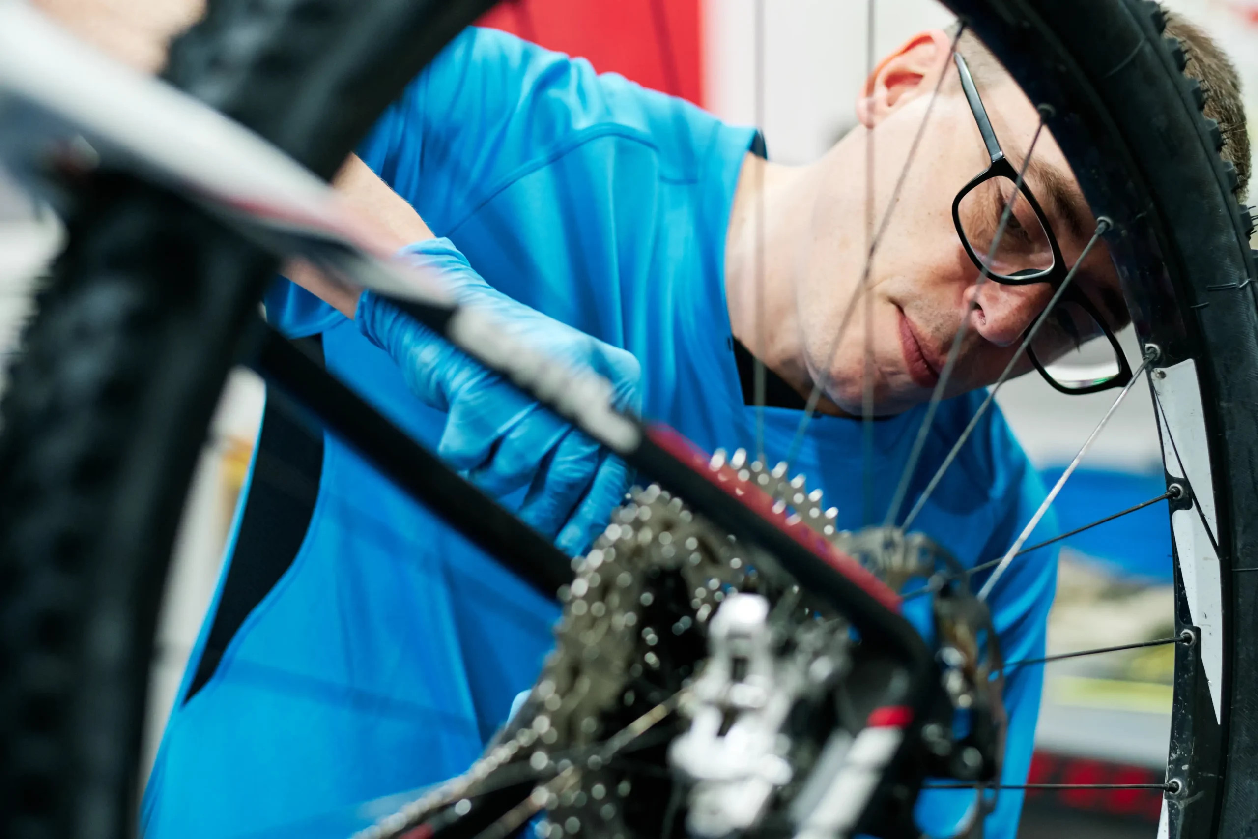 Bike repairs performed by a professional mechanic focusing on adjusting a bicycle's gear system.