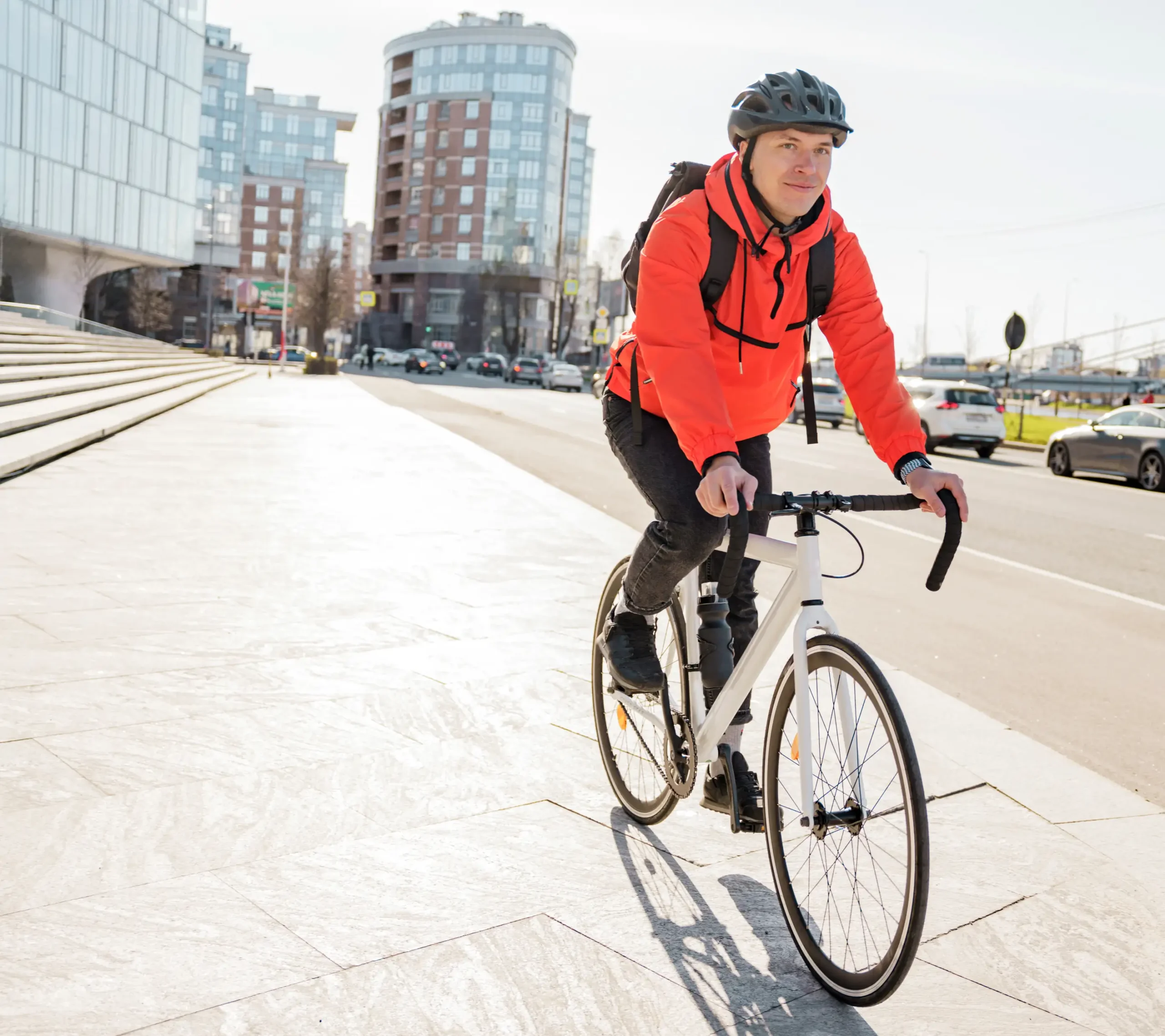 A cyclist riding a newly purchased bike from a seasonal bike sales event.