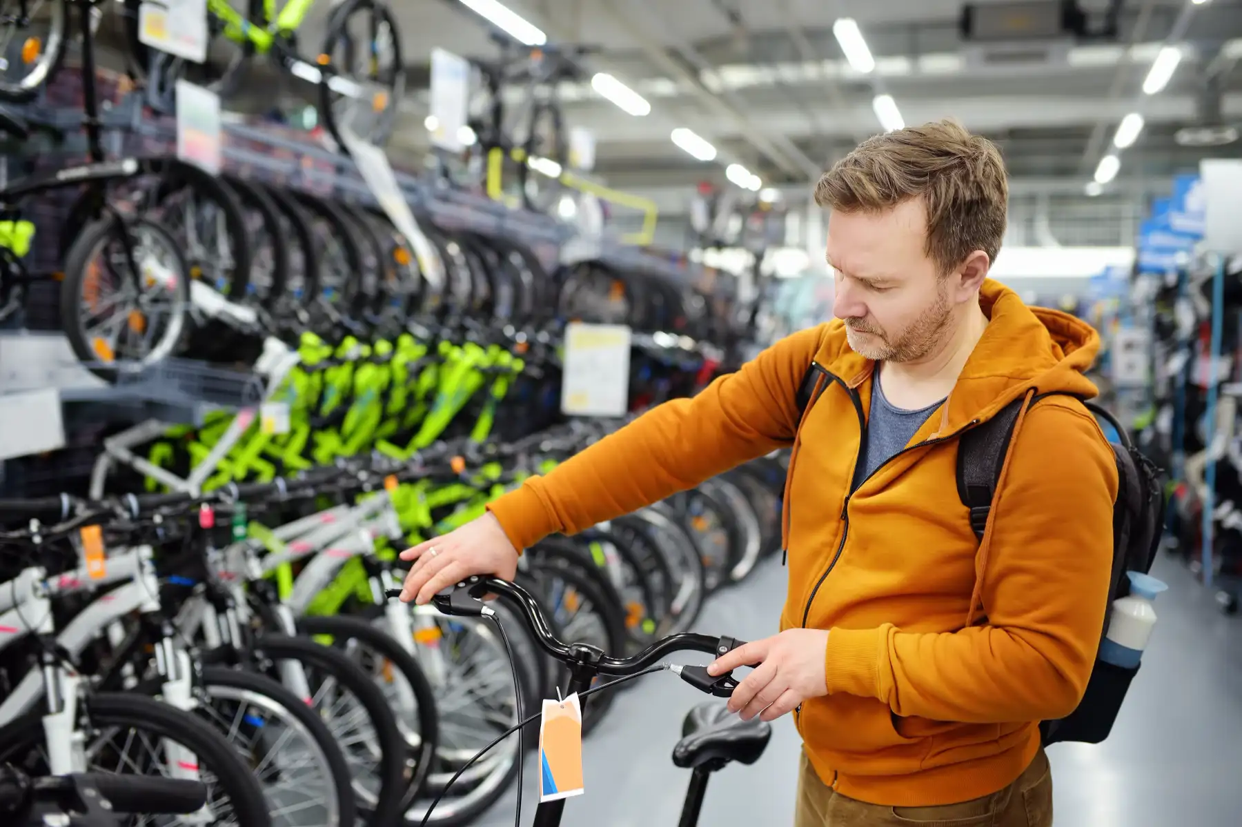 A customer selecting a bike during a bike sales event at a store.